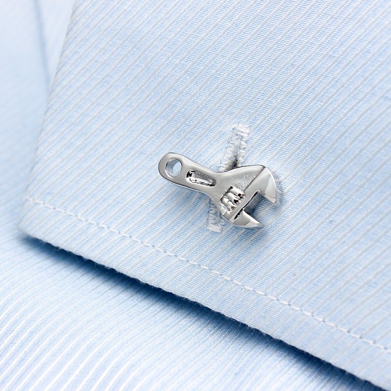 A pair of elegant Spanner Cufflinks made from titanium alloy, featuring a sleek design and perfect plating finish, displayed in a hard-sided presentation box.