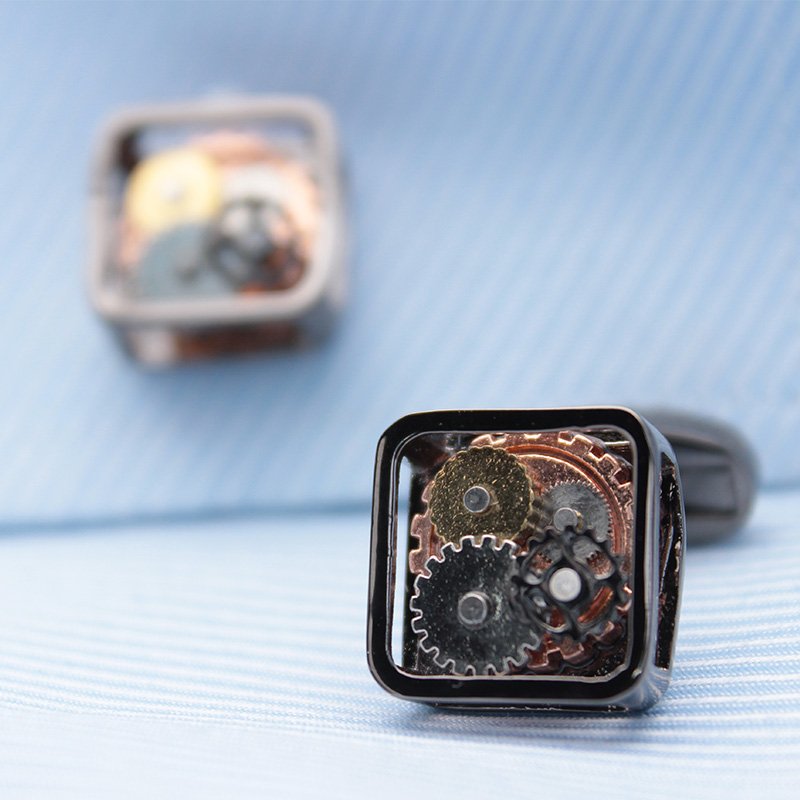 A pair of stylish Steampunk Gears Cufflinks made from stainless steel with intricate gear designs, presented in a hard-sided gift box.