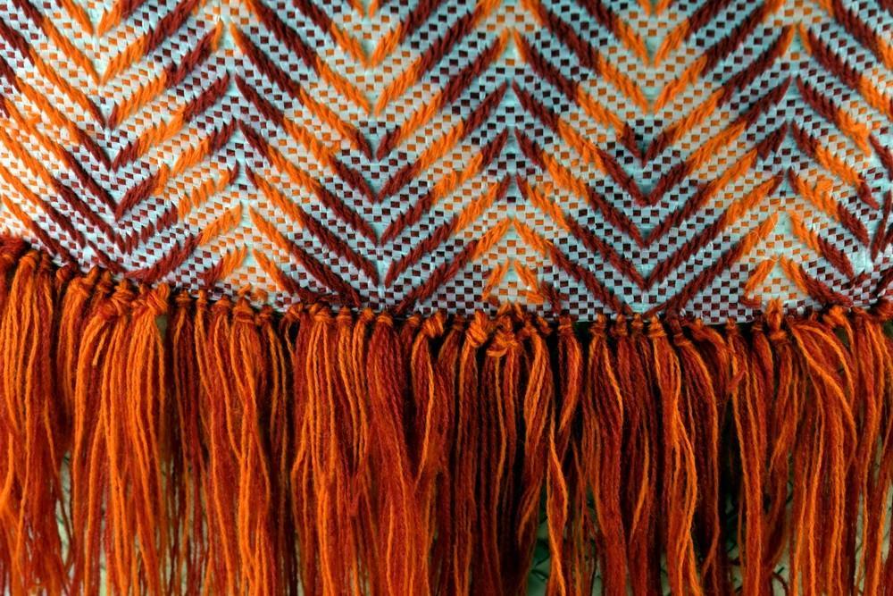 Artisan Red Orange Fringe Tote showcasing vibrant color and unique fringe design, perfect for stylish everyday use.