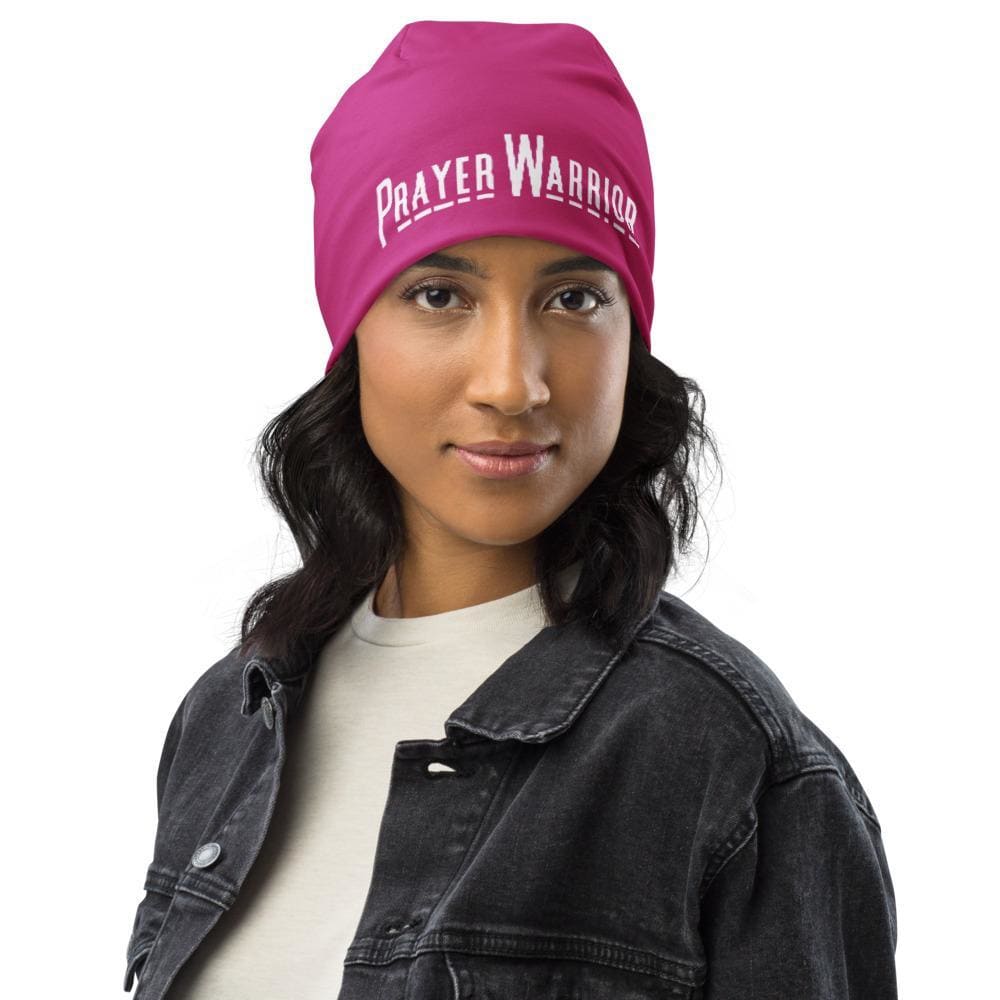 A stylish pink slouchy beanie featuring a Prayer Warrior print, designed for both men and women, showcasing its trendy and comfortable design.