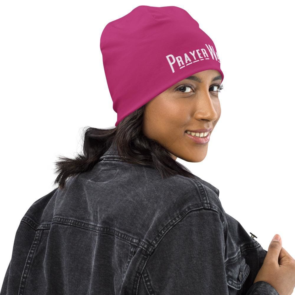 A stylish pink slouchy beanie featuring a Prayer Warrior print, designed for both men and women, showcasing its trendy and comfortable design.