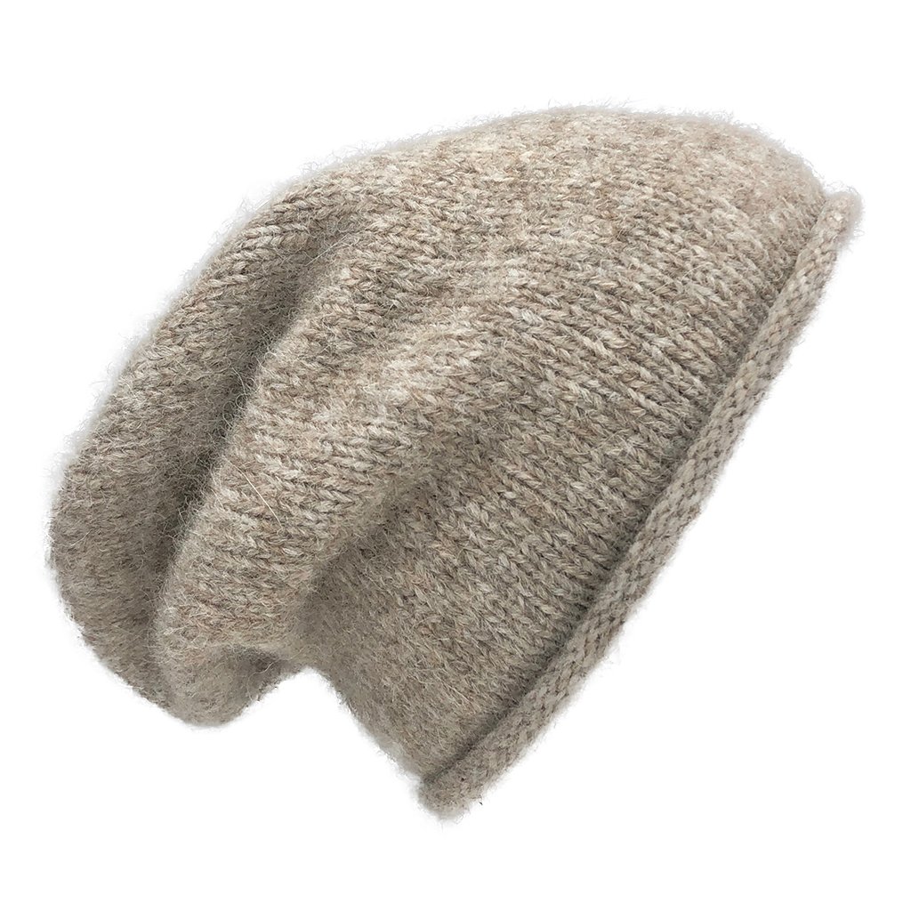 Beige Essential Knit Alpaca Beanie, handmade in Peru, showcasing its soft texture and slouchy design, perfect for winter fashion.