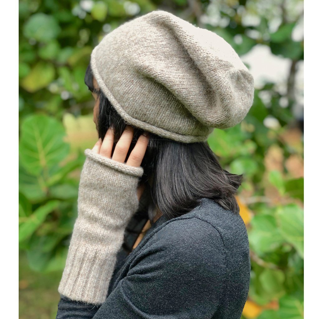 Beige Essential Knit Alpaca Beanie, handmade in Peru, showcasing its soft texture and slouchy design, perfect for winter fashion.