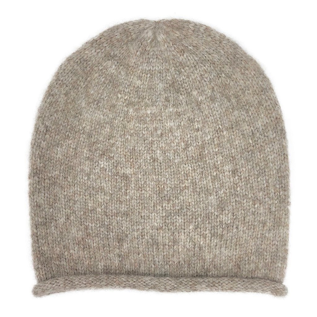 Beige Essential Knit Alpaca Beanie, handmade in Peru, showcasing its soft texture and slouchy design, perfect for winter fashion.