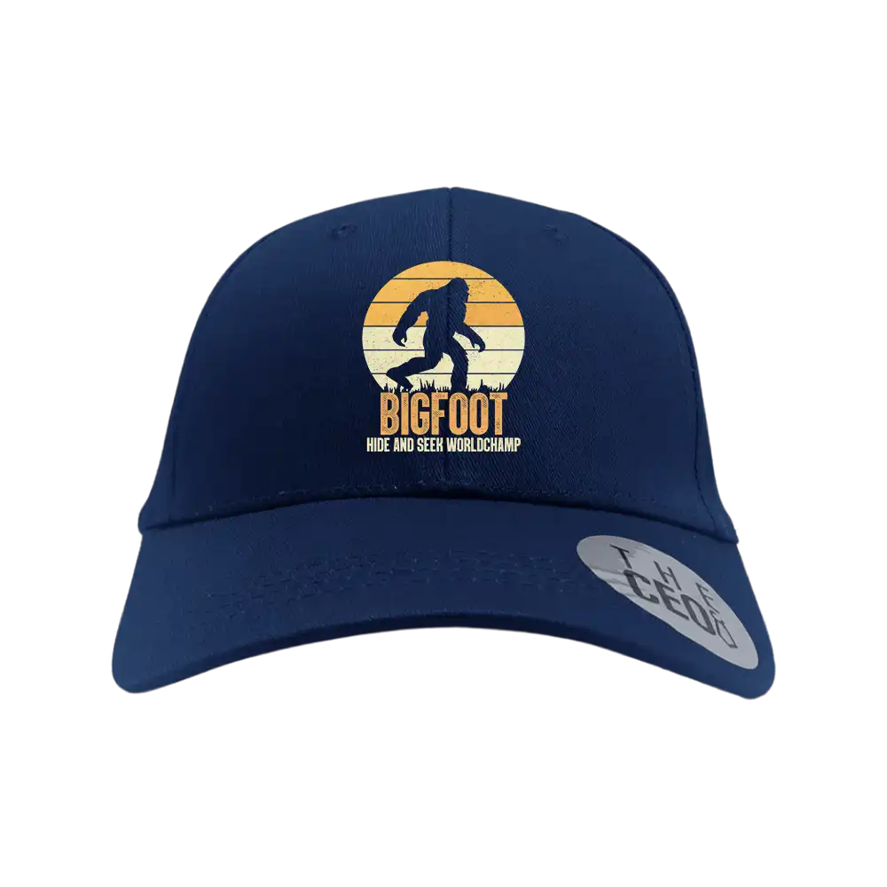 Bigfoot Hide And Seek Embroidered Baseball Hat featuring a playful design, 100% cotton material, and a comfortable snapback closure.