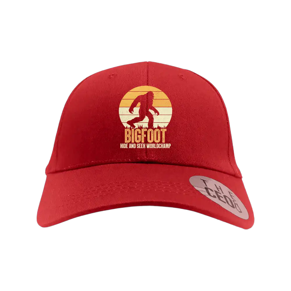 Bigfoot Hide And Seek Embroidered Baseball Hat featuring a playful design, 100% cotton material, and a comfortable snapback closure.