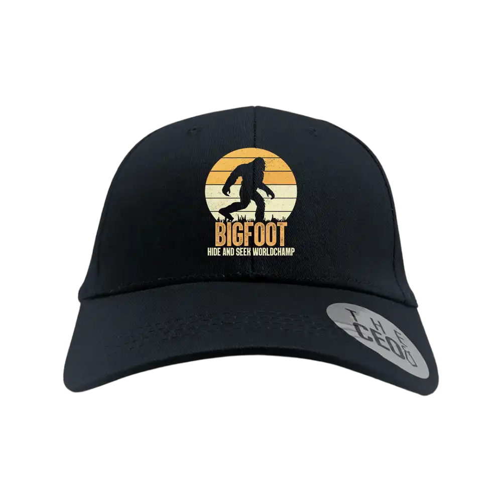 Bigfoot Hide And Seek Embroidered Baseball Hat featuring a playful design, 100% cotton material, and a comfortable snapback closure.