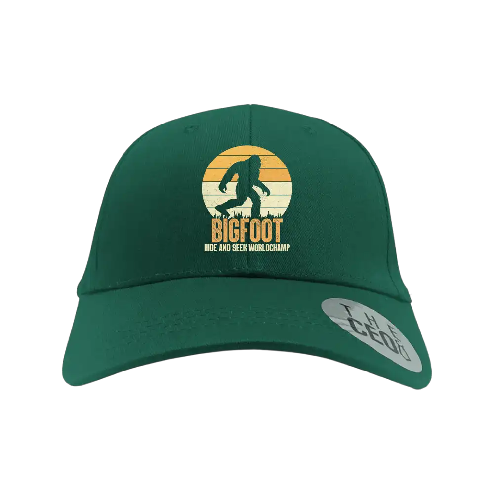 Bigfoot Hide And Seek Embroidered Baseball Hat featuring a playful design, 100% cotton material, and a comfortable snapback closure.