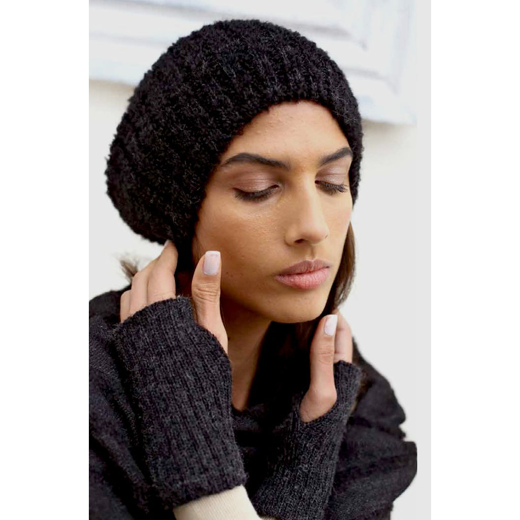 Black Loop Knit Alpaca Beanie showcasing a soft ribbed texture, perfect for winter wear, handmade in Peru.