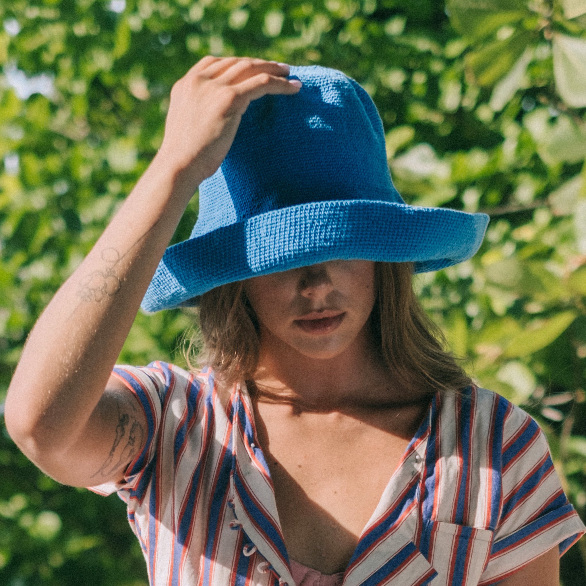 BLOOM Crochet Hat in Mosaic Blue, featuring a soft crochet design inspired by Calla Lily shape, perfect for outdoor activities.