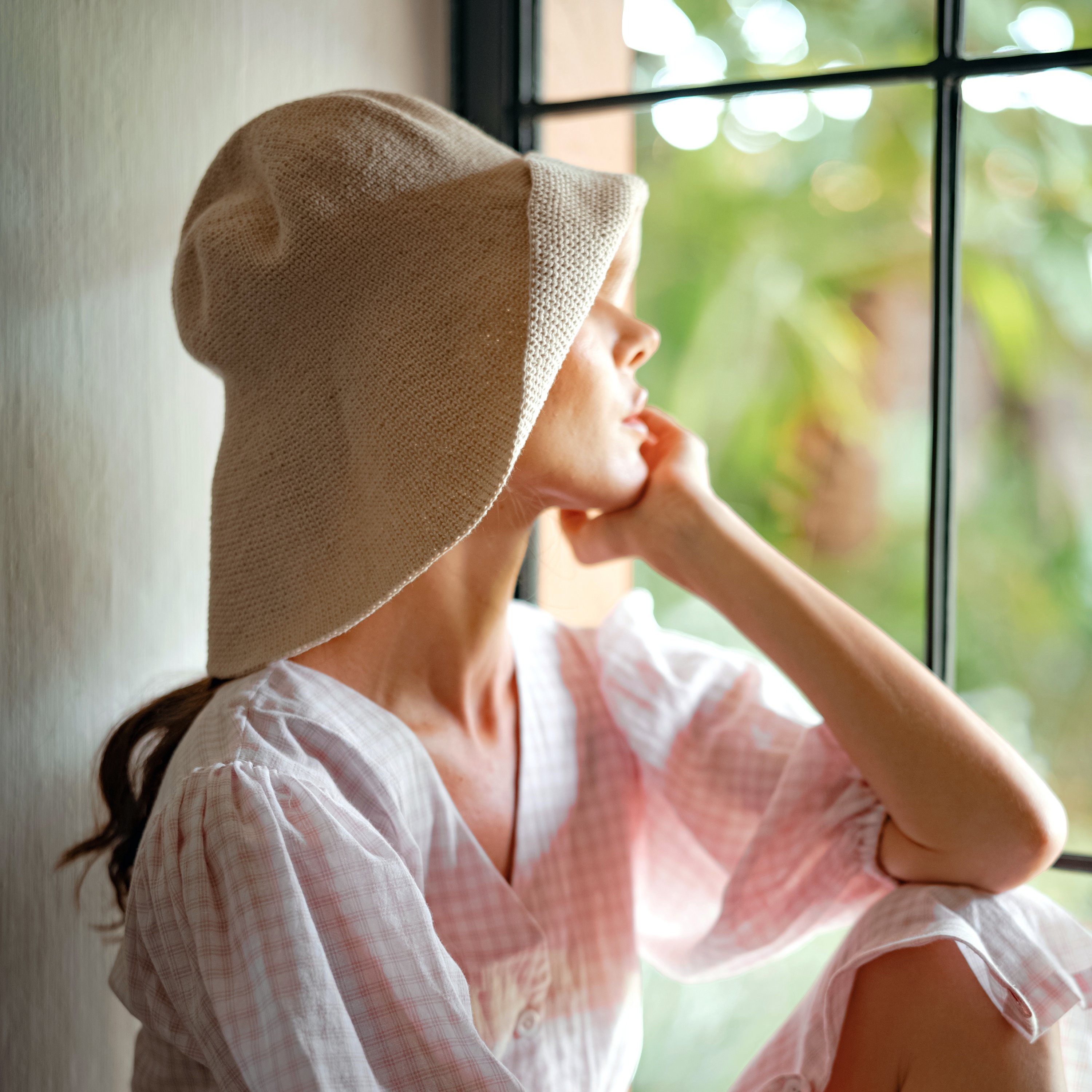 BLOOM Crochet Hat in Off White, showcasing its soft, shapeable design inspired by Calla Lily flowers, perfect for outdoor activities.