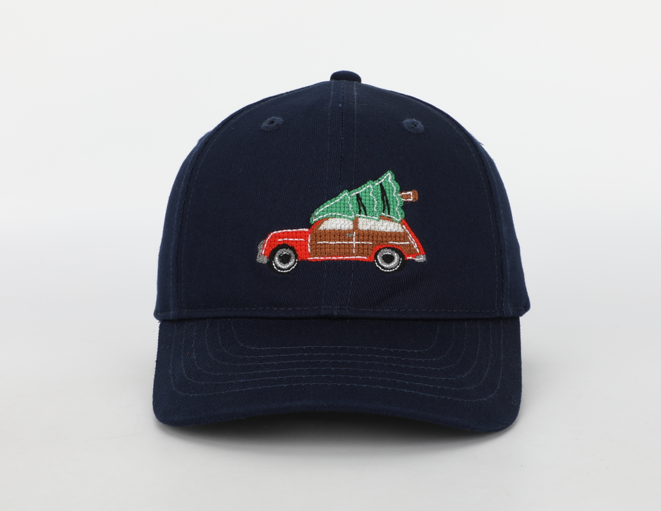 A festive Christmas Tree Wagon Hat for children, featuring needlepoint embroidery, a cognac leather adjustable strap, and a brass embossed buckle.