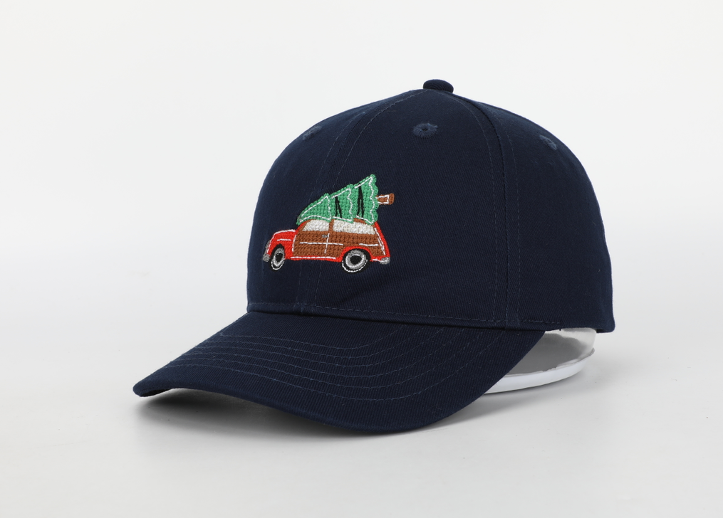 A festive Christmas Tree Wagon Hat for children, featuring needlepoint embroidery, a cognac leather adjustable strap, and a brass embossed buckle.