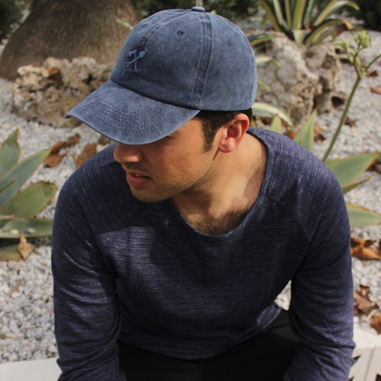 Cody Dad Hat featuring a curved brim and embroidered shovel and ax logo, showcasing a unique snow washed finish.