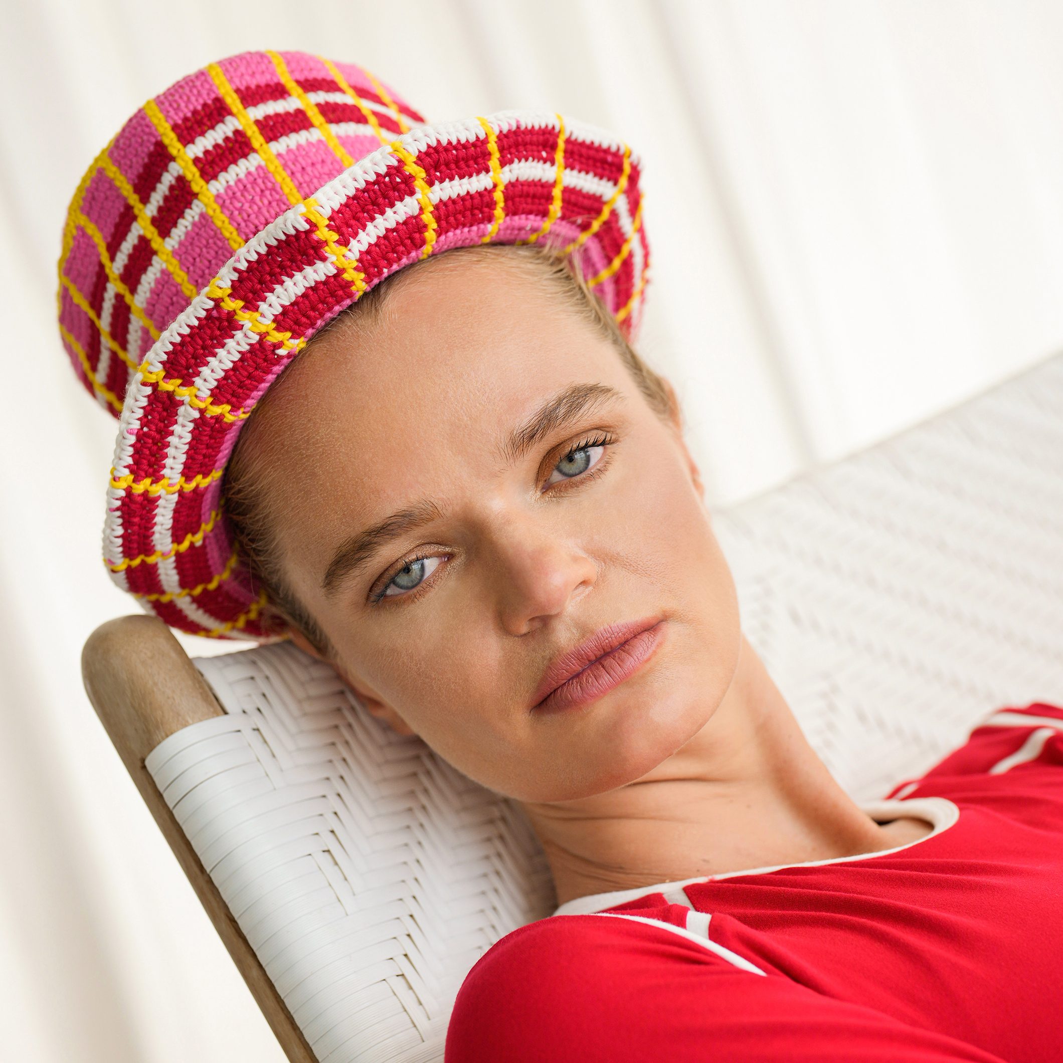 A stylish DERBY Plaid Crochet Hat hand-crocheted in vibrant colors, showcasing a plaid pattern, perfect for sunny outdoor occasions.