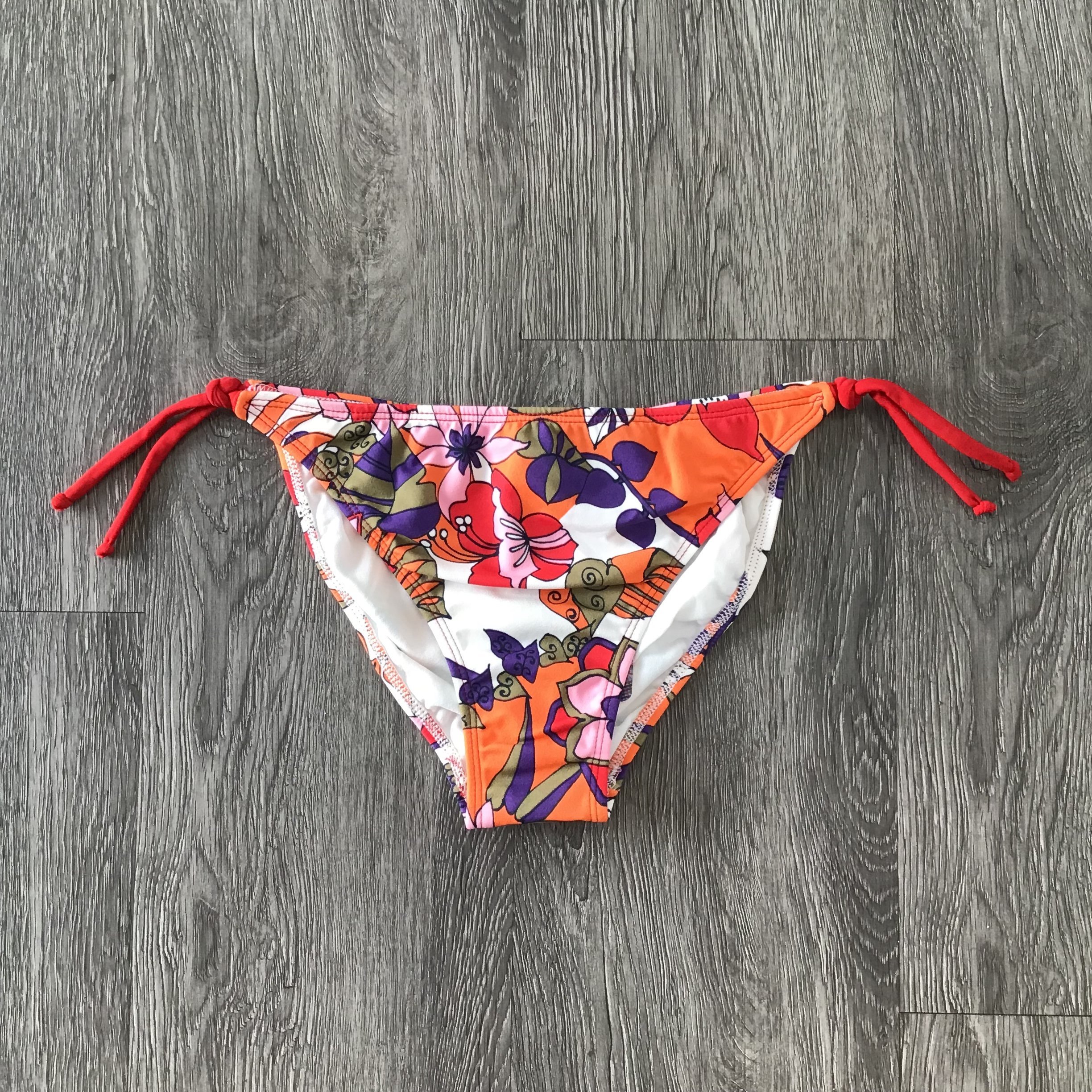 Eva Orange Bikini Bottom showcasing vibrant color and stylish design, perfect for beachwear.