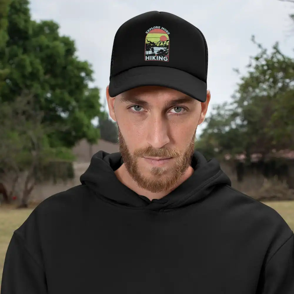 Man wearing hiking-themed cap.