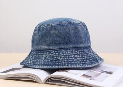 A stylish faded denim bucket hat, showcasing a vintage design perfect for trendsetters.