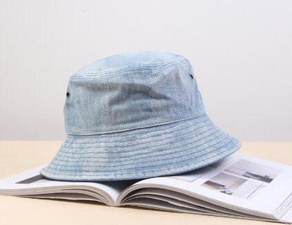 A stylish faded denim bucket hat, showcasing a vintage design perfect for trendsetters.