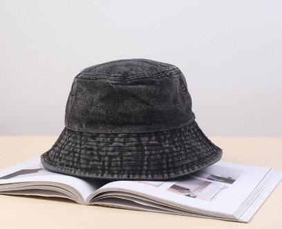 A stylish faded denim bucket hat, showcasing a vintage design perfect for trendsetters.