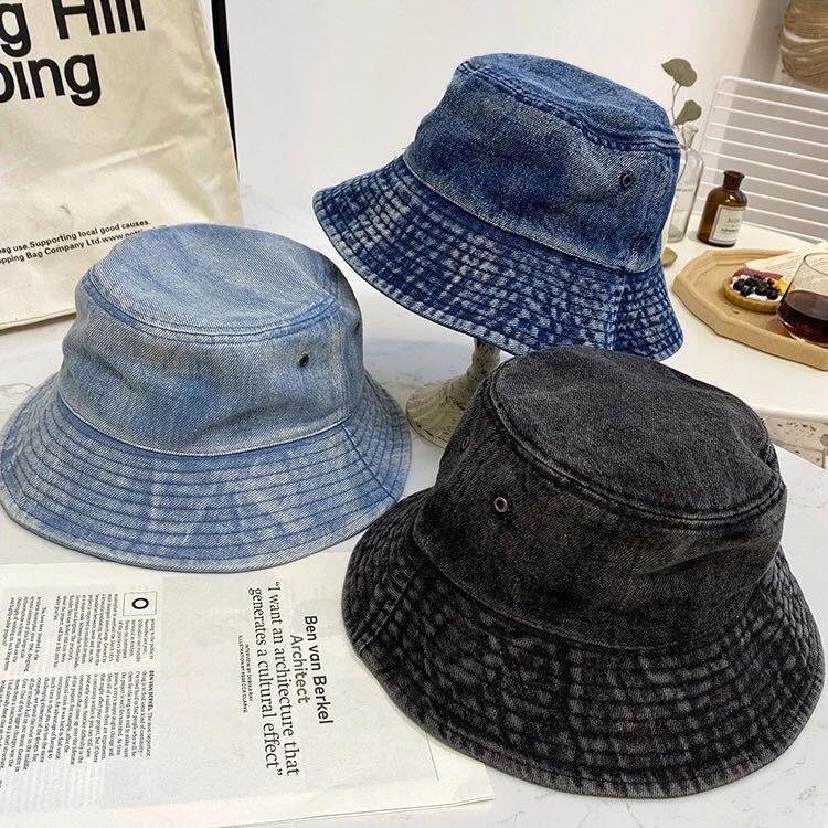 A stylish faded denim bucket hat, showcasing a vintage design perfect for trendsetters.