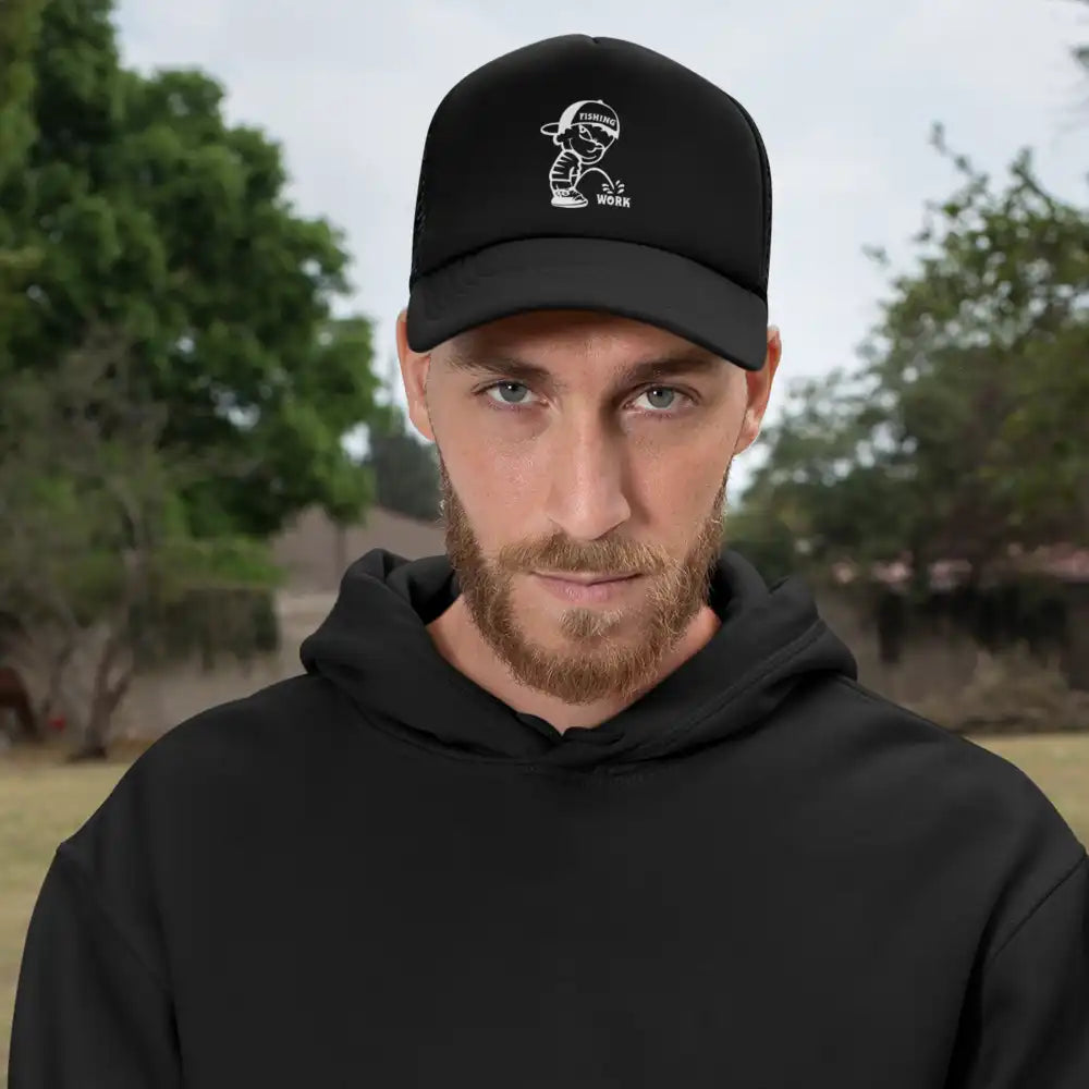 Man in black cap outdoors.