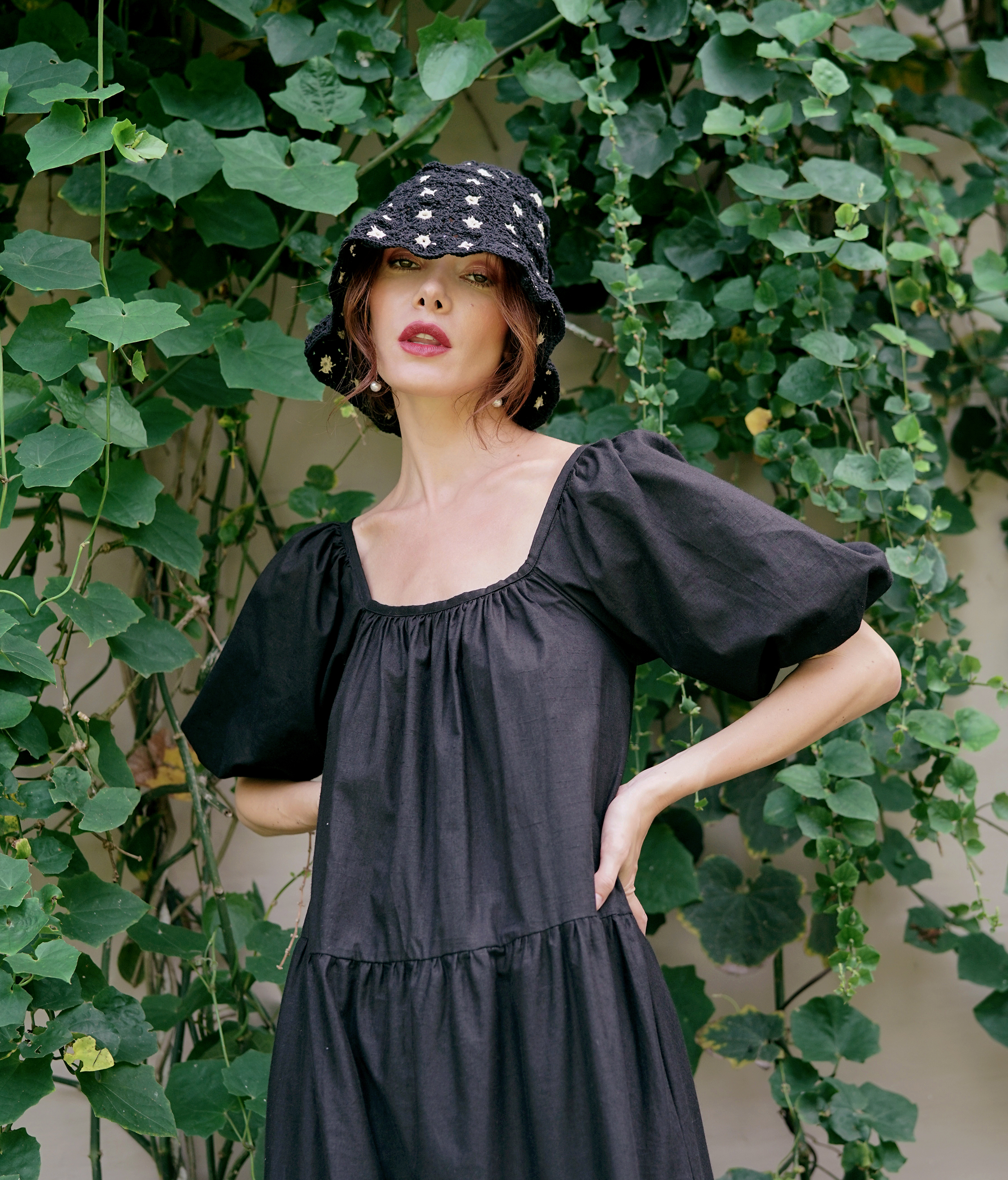 FLORA Crochet Hat in Black featuring a beautiful flower pattern, handcrafted from 100% cotton yarn, perfect for sunny outdoor occasions.