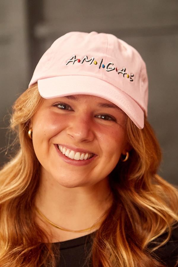 A stylish white hat labeled 'Bride' alongside colorful hats labeled 'Amigas', perfect for bachelorette parties.