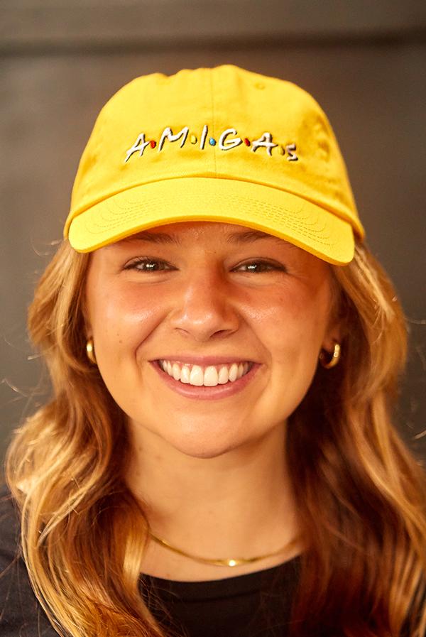 A stylish white hat labeled 'Bride' alongside colorful hats labeled 'Amigas', perfect for bachelorette parties.