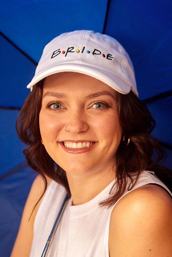 A stylish white hat labeled 'Bride' alongside colorful hats labeled 'Amigas', perfect for bachelorette parties.