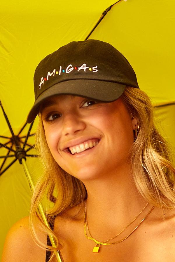 A stylish white hat labeled 'Bride' alongside colorful hats labeled 'Amigas', perfect for bachelorette parties.