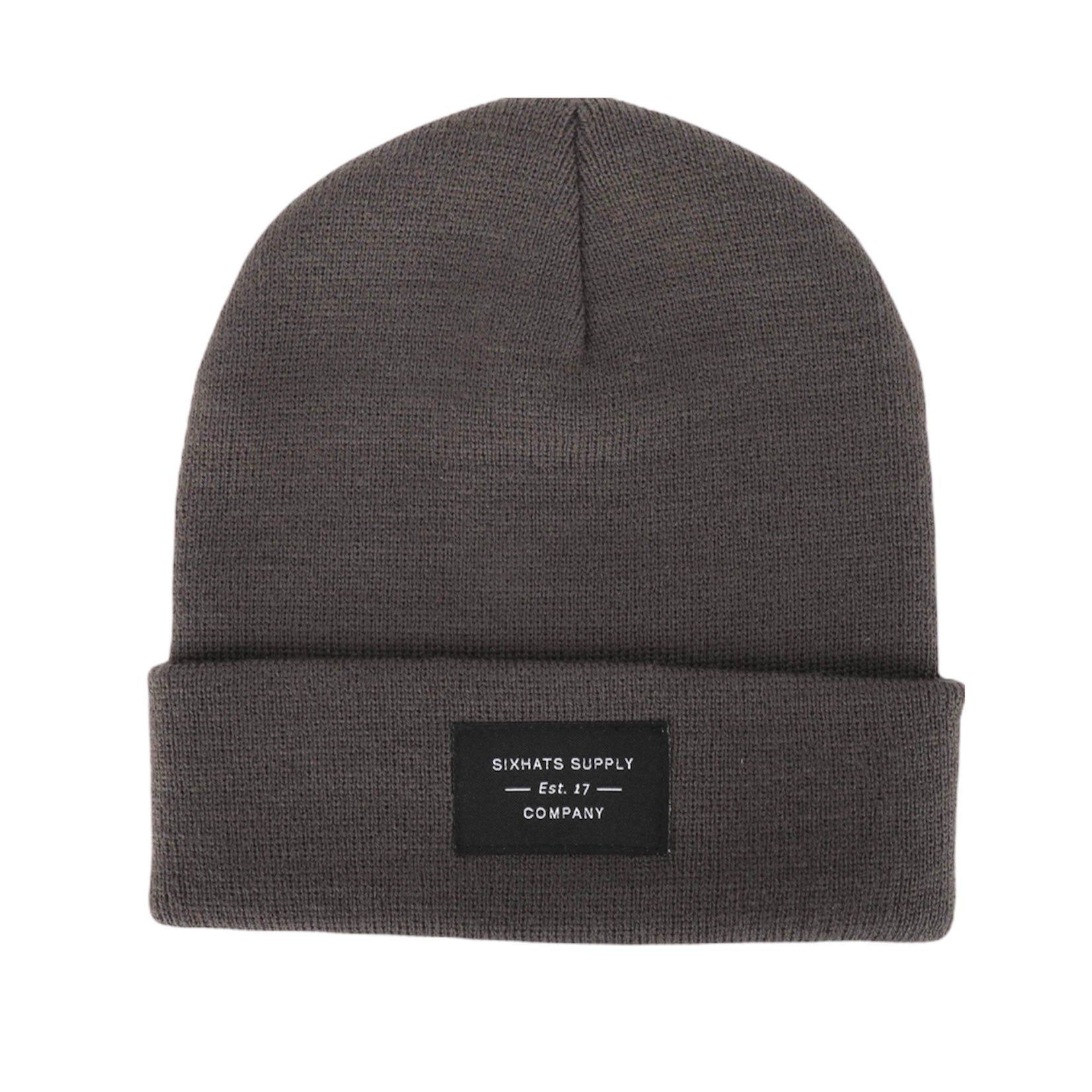 A soft grey folding beanie displayed on a wooden surface, showcasing its stylish design and classic black woven label.