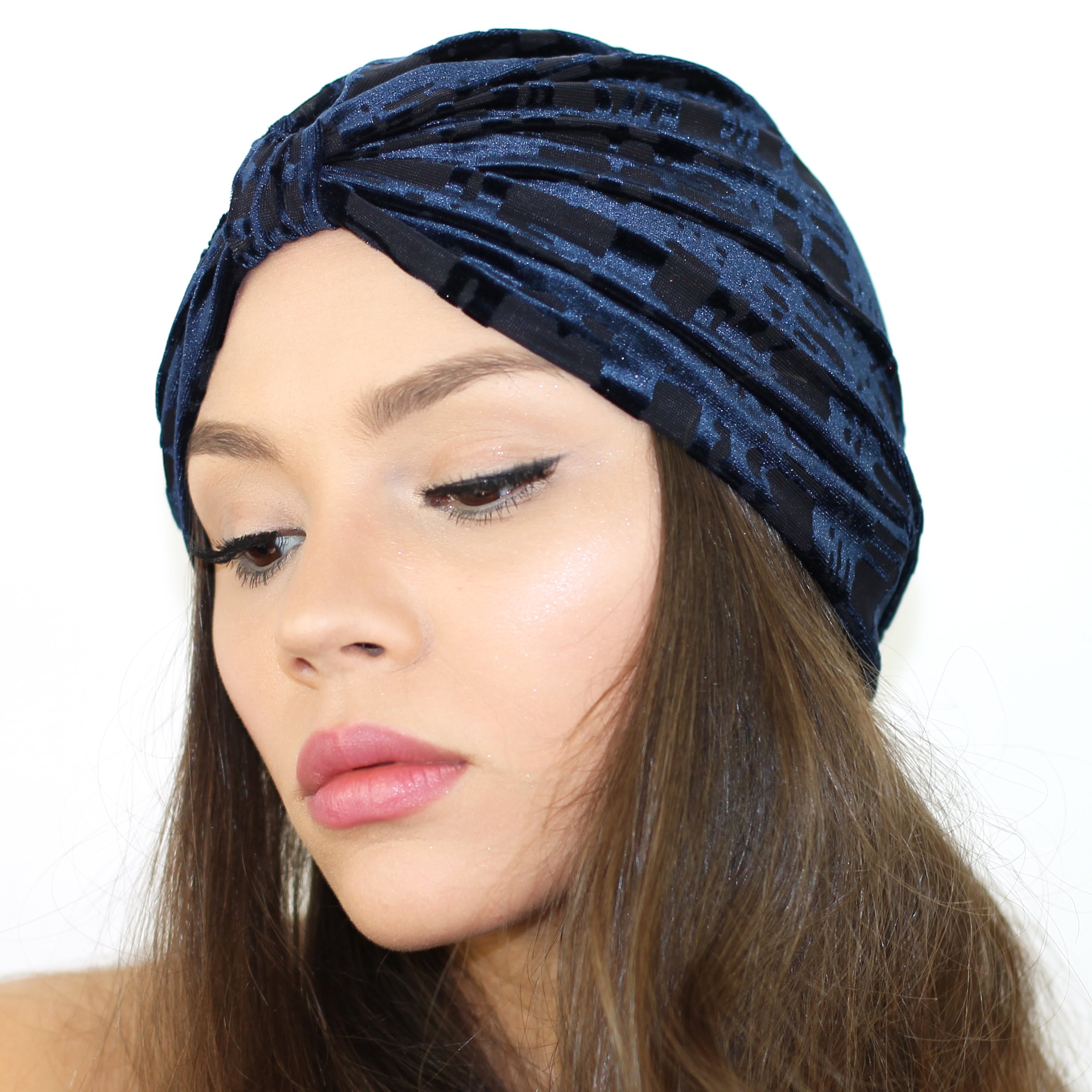 A stylish Gridiron Burnout Turban made of lightweight stretch velvet, available in Berry, Navy, and Black colors, showcasing its plush texture and cinched back design.