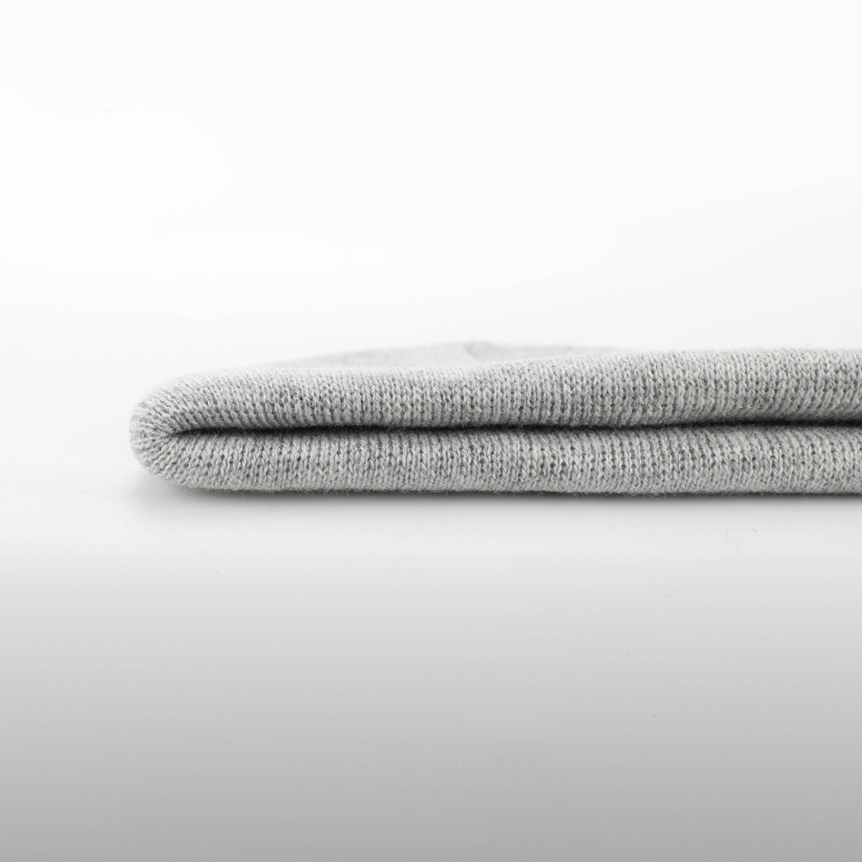 Heather Grey Folding Beanie displayed on a neutral background, showcasing its soft texture and stylish design.