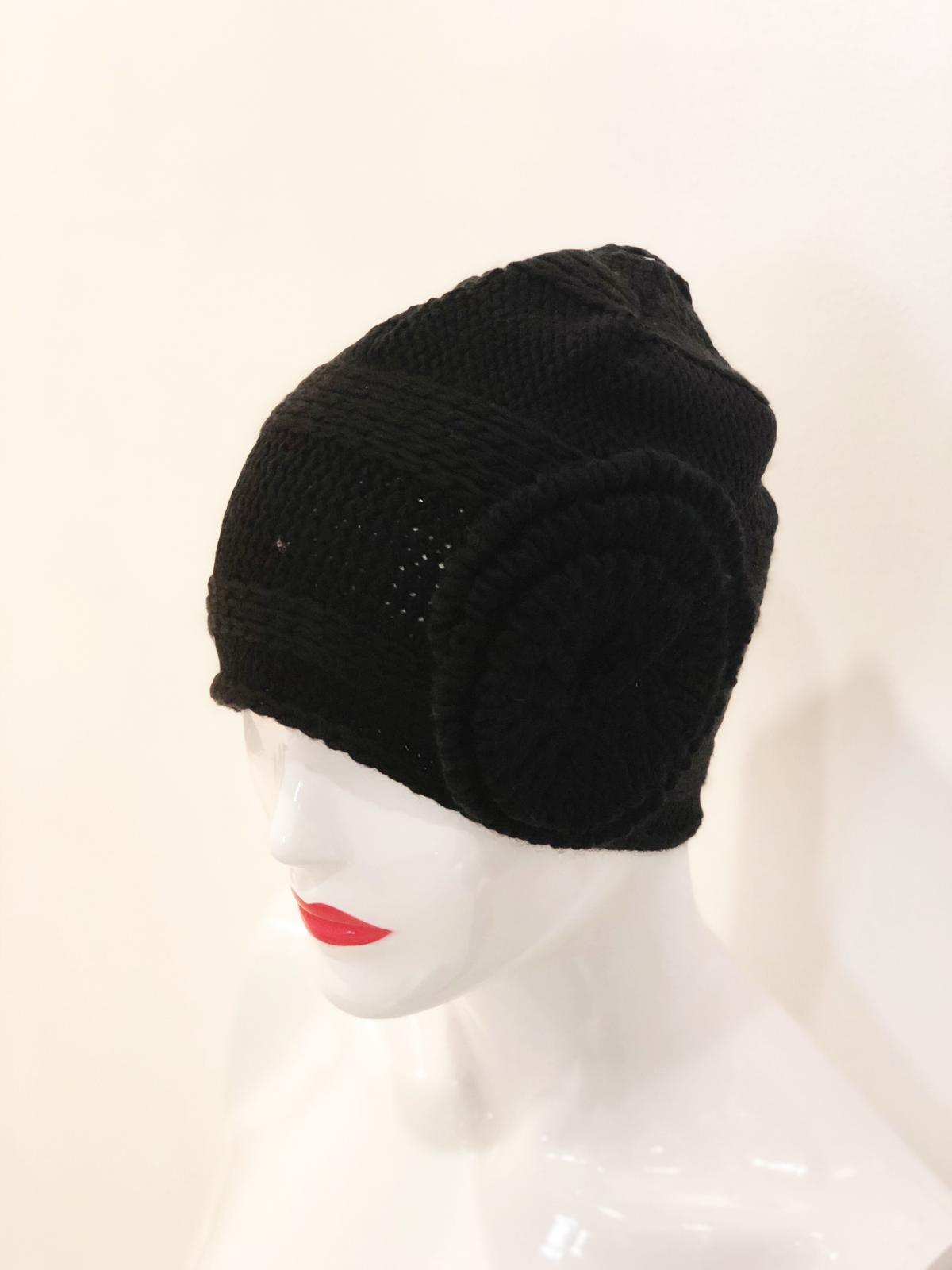 A stylish black beanie featuring a jumbo self button, perfect for winter wear.