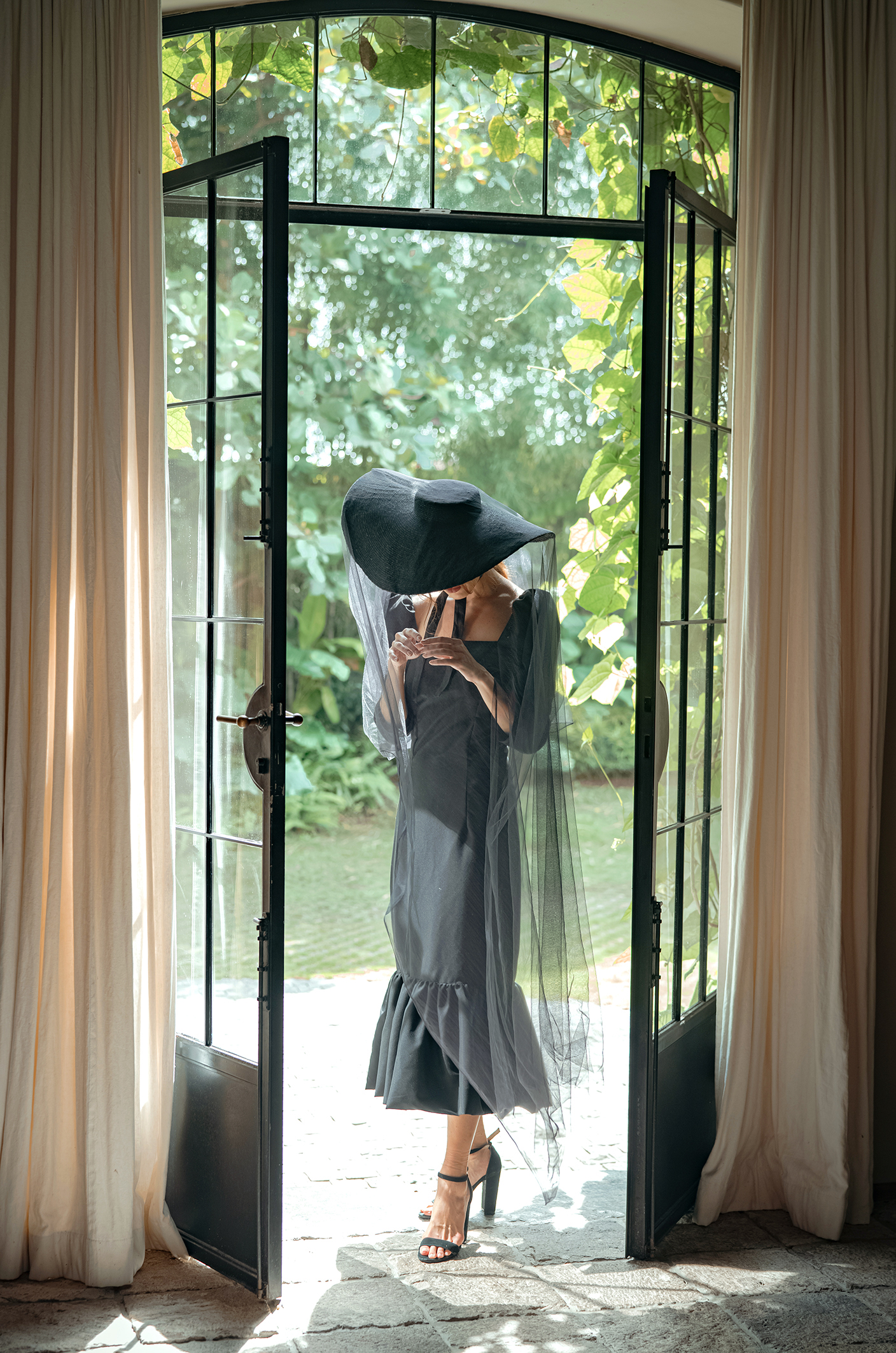 Lola Wide Brim Jute Straw Hat in black, showcasing its elegant design and natural jute material.