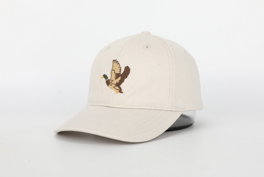 A stylish Mallard Hat for children featuring a cognac leather adjustable strap and unique needlepoint embroidery designs.