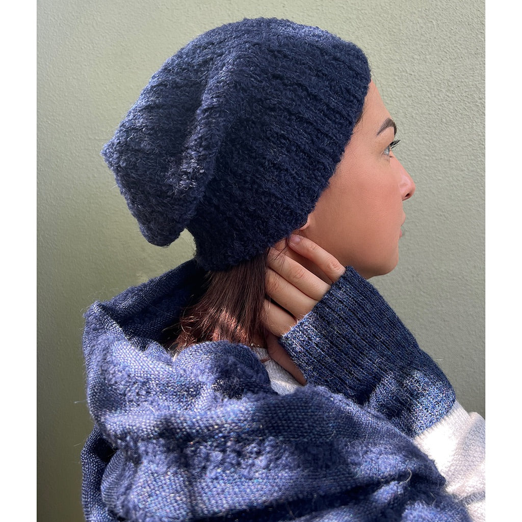 Navy Loop Knit Alpaca Beanie showcasing a slouchy design with subtle ribbed stripes, made from soft alpaca fiber.