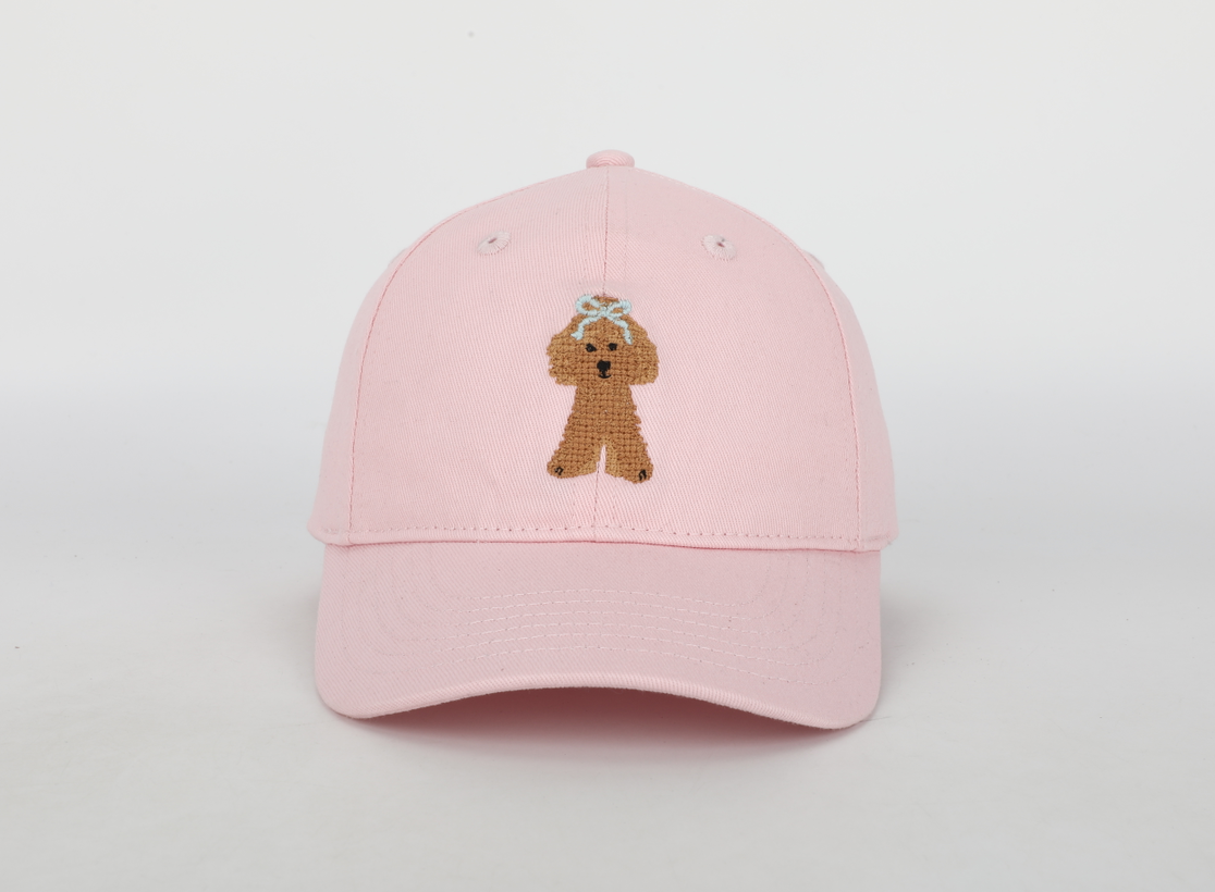 A stylish Pink Golden Doodle Hat for children, featuring a cognac leather adjustable strap and needlepoint embroidery designs.