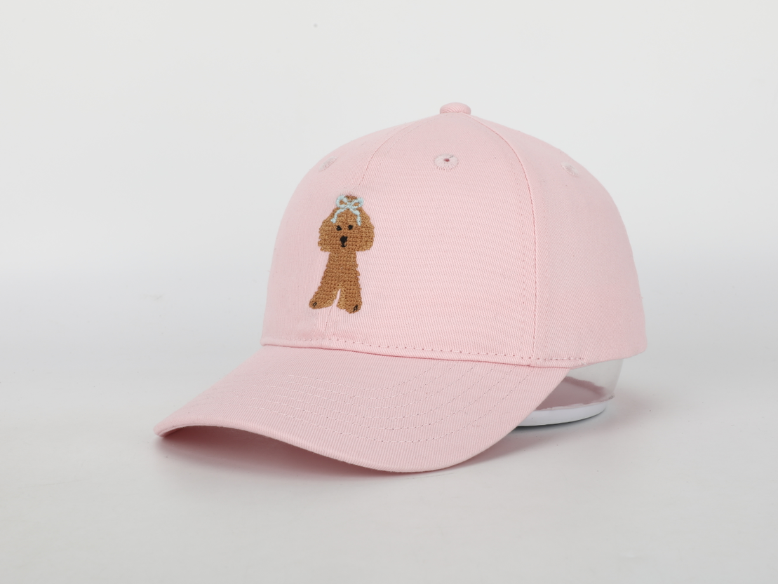 A stylish Pink Golden Doodle Hat for children, featuring a cognac leather adjustable strap and needlepoint embroidery designs.