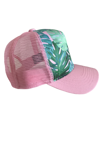 Pink Monstera Trucker Hat featuring a vibrant monstera leaf pattern and a pink curved visor with mesh back.