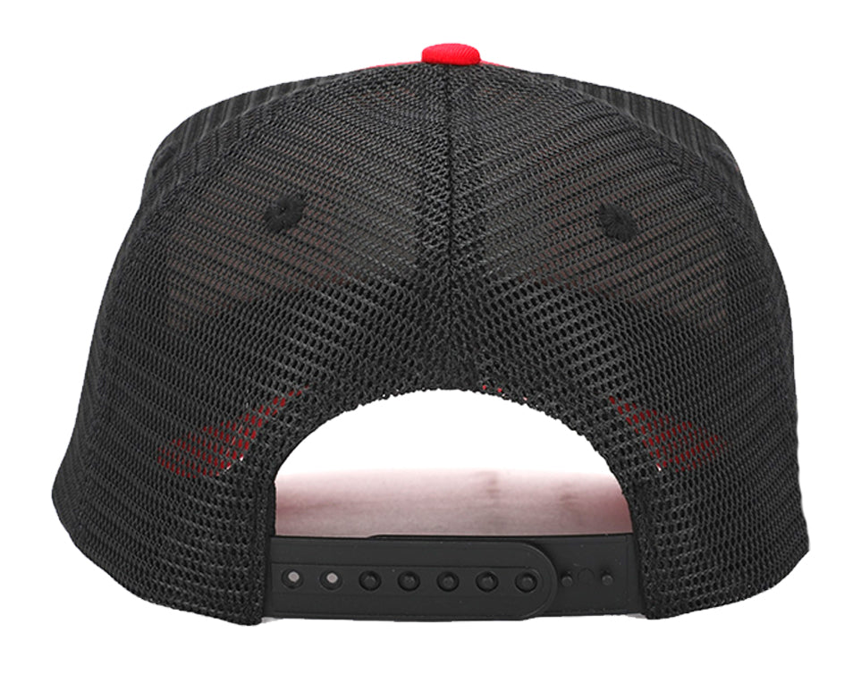 Red and black snapback hat with cork brim and mesh back, featuring a round recycled cork patch.