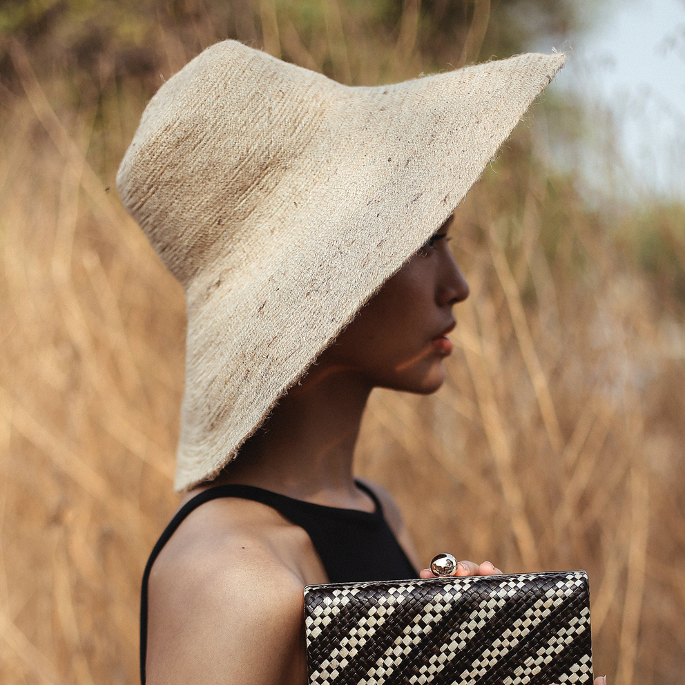 RIRI Jute Handwoven Straw Hat in Natural Beige with a wide brim, showcasing its eco-friendly jute material and comfortable cotton inner strap.