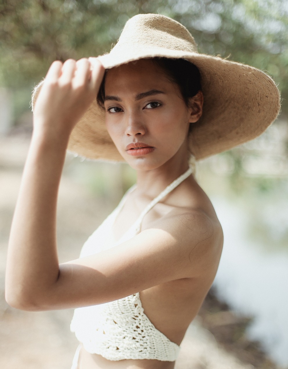 RIRI Jute Handwoven Straw Hat in Natural Beige with a wide brim, showcasing its eco-friendly jute material and comfortable cotton inner strap.