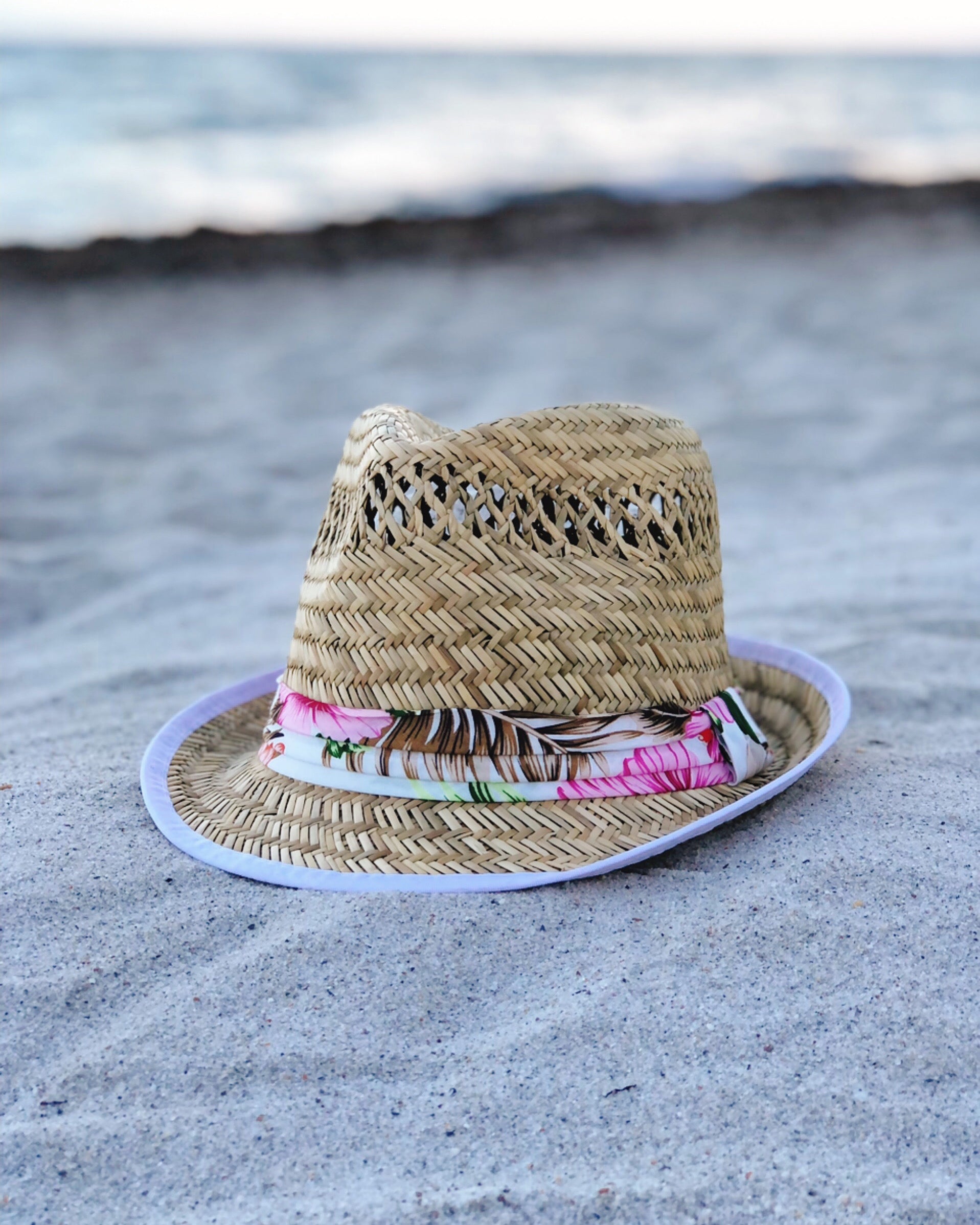 A stylish 'Say Aloha' Natural Straw Fedora Hat with a cotton band trim and a 2-inch brim, perfect for sunny days.