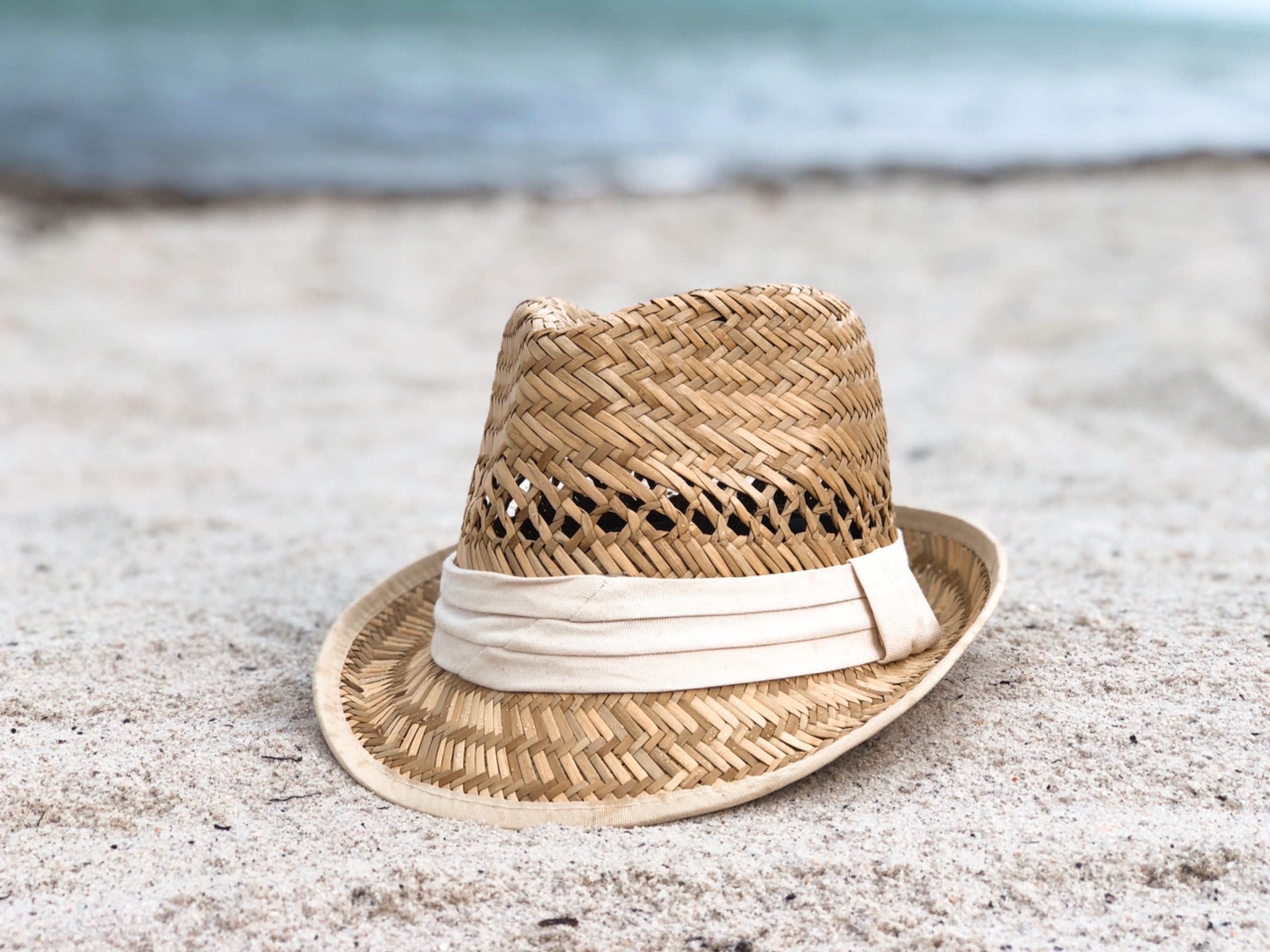 A stylish 'Say Aloha' Natural Straw Fedora Hat with a cotton band trim and a 2-inch brim, perfect for sunny days.