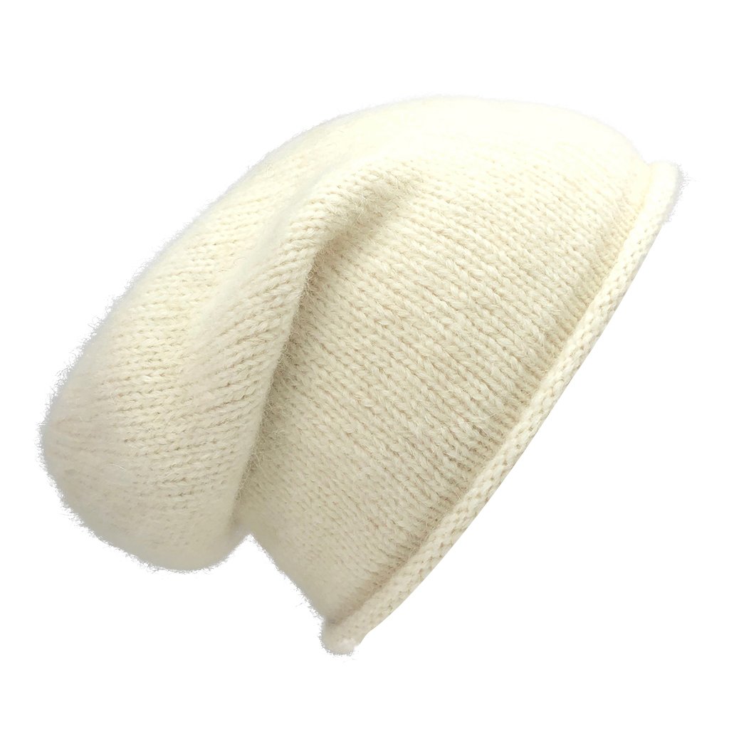 A stylish Snow Essential Knit Alpaca Beanie in a soft snow color, showcasing its slouchy design and luxurious texture, perfect for winter wear.