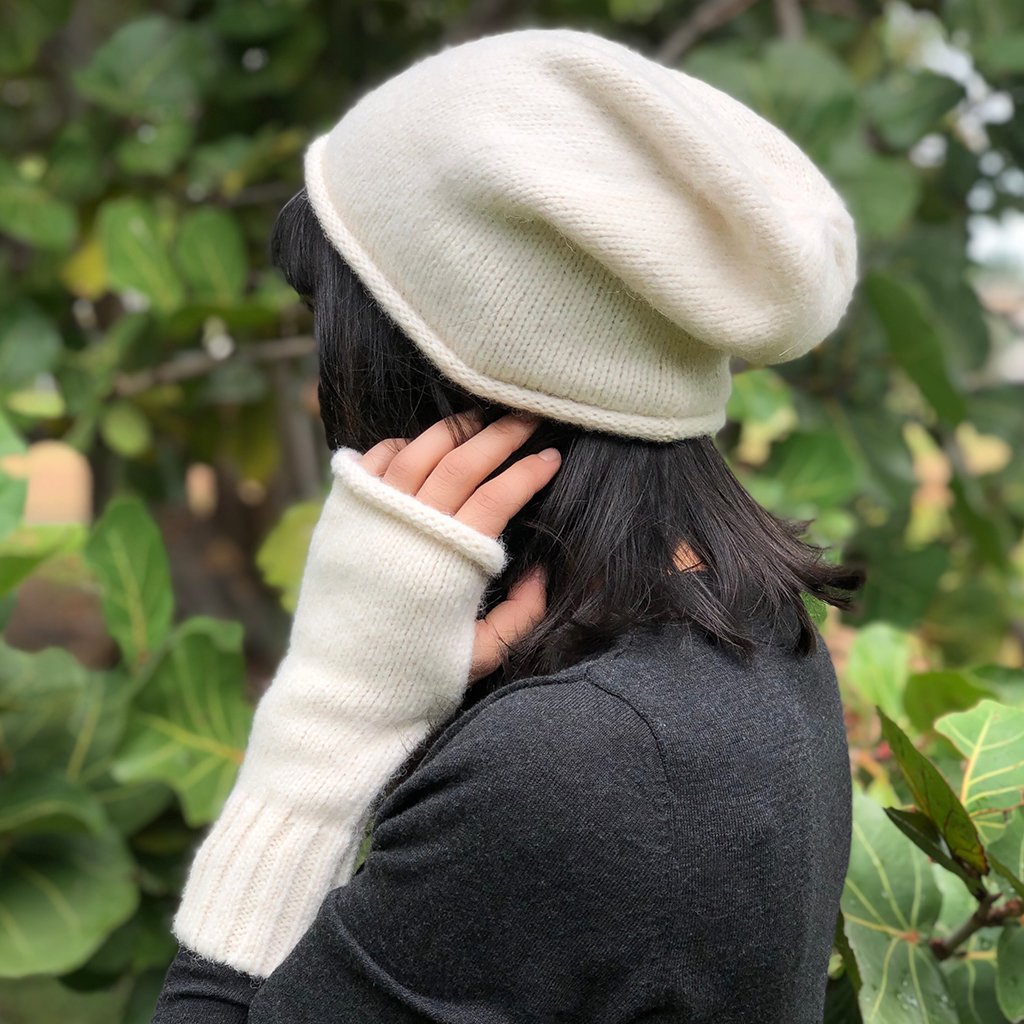 A stylish Snow Essential Knit Alpaca Beanie in a soft snow color, showcasing its slouchy design and luxurious texture, perfect for winter wear.