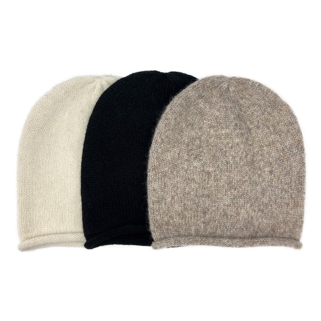 A stylish Snow Essential Knit Alpaca Beanie in a soft snow color, showcasing its slouchy design and luxurious texture, perfect for winter wear.