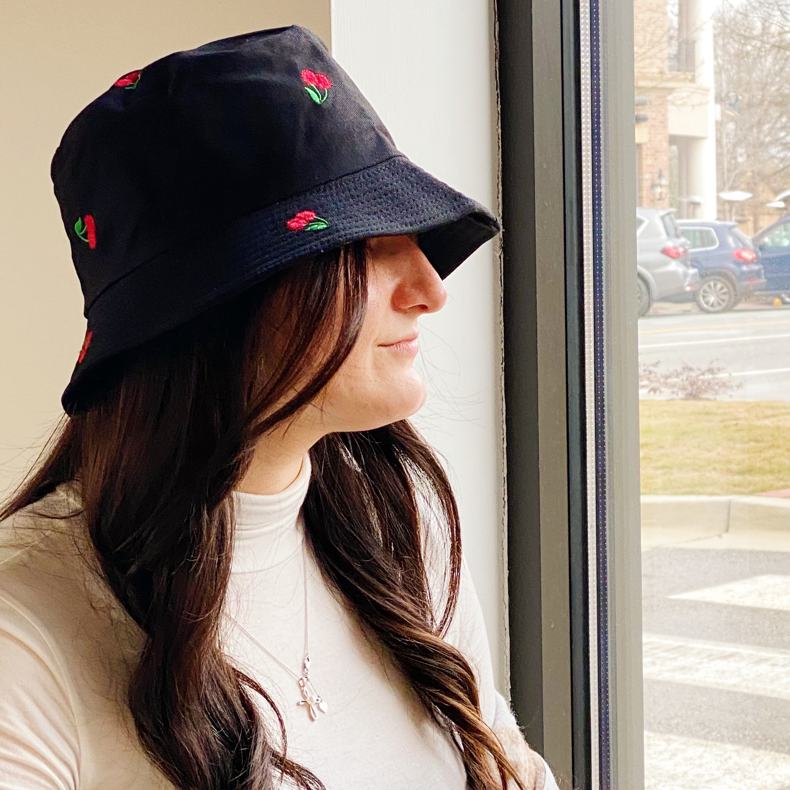 A colorful bucket hat with embroidered fruit patterns, made of high-quality cotton, perfect for sunny days.